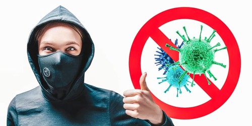 Portrait of a girl in a protective mask who shows up her finger against the background of the stop viruses sign.