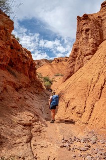 Climber in a canyon with a dry stream bed