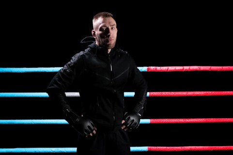 Mixed martial artist posing in boxing ring. Concept of mma