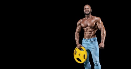 Isolated muscular man on a black background. Bodybuilding and fitness concept. Panorama.