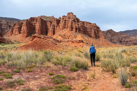 Climber in a canyon with a dry stream bed