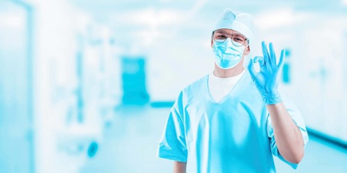 Doctor in clinic shows ok sign. Medicine concept.