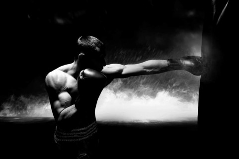 Professional boxer hits the bag. The concept of sport