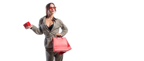 Charming brunette in glasses posing in the studio with red bags and a box for jewelry. White background. Shopping concept.