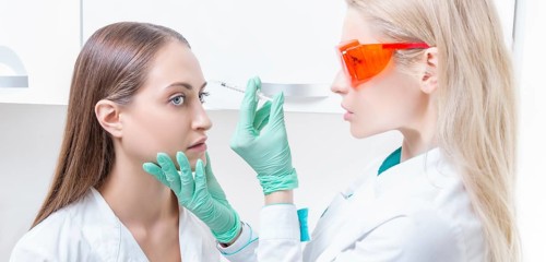 Portrait of two girls in white coats. The concept of cosmetology