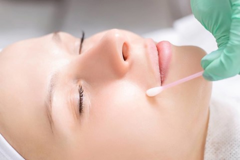 Beautiful girl gets face peeling. Skin health concept. Beauty salons.