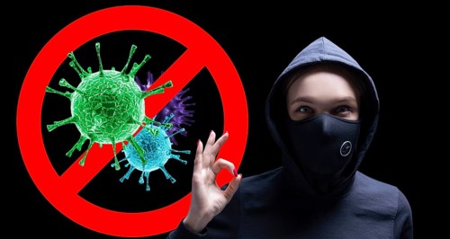 Portrait of a girl in a protective mask who shows up her finger against the background of the stop viruses sign.