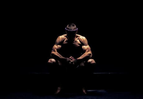 World champion in Thai boxing is sitting in the ring and getting ready for the next fight. The concept of sport