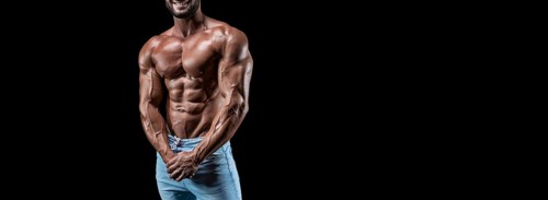No name sexy muscular man in jeans posing on black background. Bodybuilding and fitness concept.