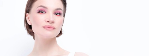 Portrait of a beautiful girl with provocative makeup. White background. Beauty concept. High quality
