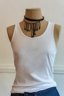 A mannequin dressed up with a white tank top. Stylish and fashion concept