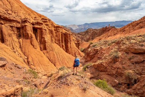 Climber in a canyon with a dry stream bed