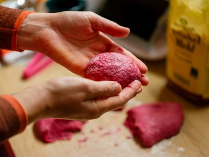 Hand moulding the dough for beetroot burger buns