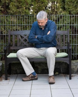 Man with grey hair and a full beard