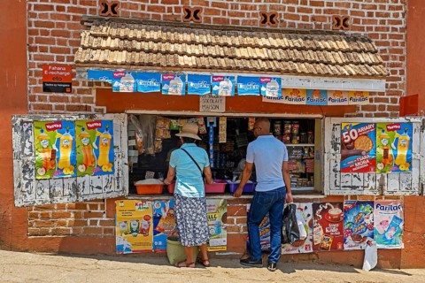 Malagasy customers buying food in little grocery shop in the city Fianarantsoa