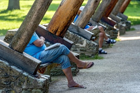 Men relaxing on benches between supporting beams of Gradierbau I