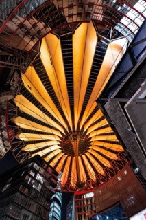 Modern roof construction with warm orange lighting in the city
