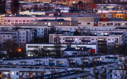 View in the evening at blue hour of high-rise buildings and apartment blocks with rental flats and condominiums in the Berlin district of Marzahn-Hellersdorf