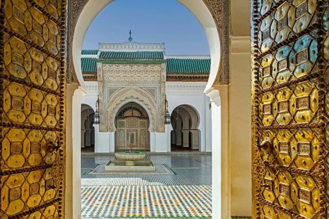 Main entrance with bronze doors and courtyard of the al-Qarawiyyin Mosque and university in the old medina of the city Fes