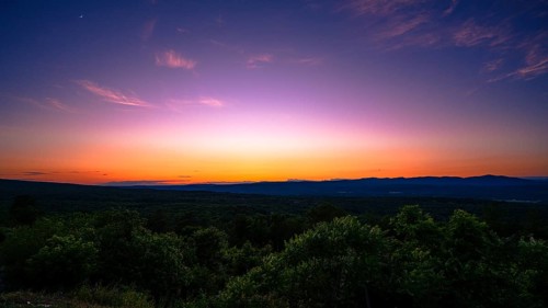 Sun sets behind the Catskills Mountains