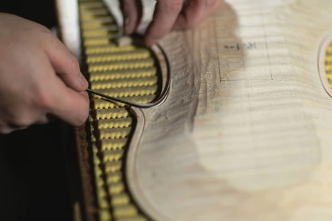 Unrecognizable luthier lute maker artisan hands in his workshop try