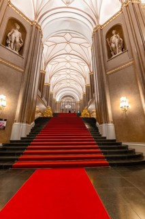 Interior of the Rotes Rathaus with red carpet and elegant staircase