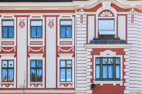 Red and white painted facade of an Art Nouveau house from 1908 on Dreifaltigkeitsplatz
