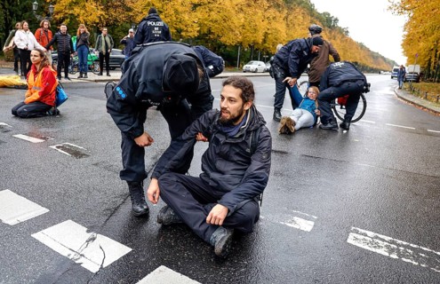 Police officers carry last generation climate activists from Strasse des 17. The Last Generation has called for a mass occupation action