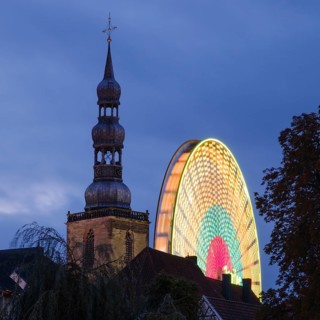 Tower of St Peter's Church with Ferris wheel