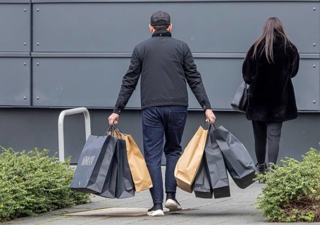 Consumer tourist lugging shopping bags