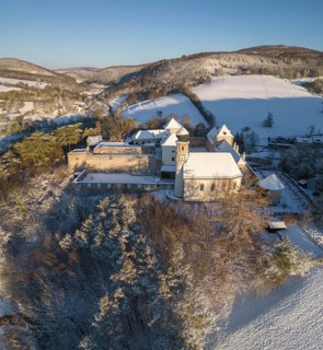 Aerial view of castle and church in winter
