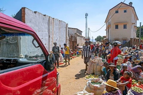 Malagasy vendors selling fruit and vegetables at food market in the streets of city Ambalavao