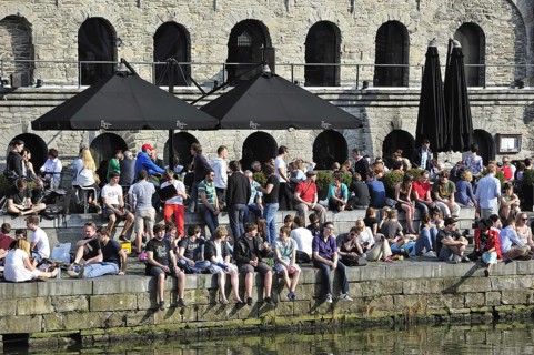 People enjoying the first spring sun by the waterside along the Graslei at Ghent