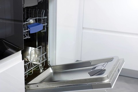 White modern dishwasher in the interior of a white kitchen