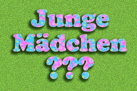 The words boy and girl with ??? three question marks written with flowers in baby colours pink and light blue on a green background