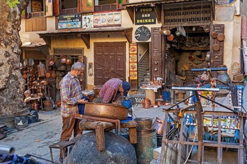 Moroccan coppersmiths working in workshop on Place Seffarine