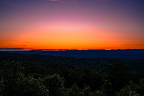 Sun sets behind the Catskills Mountains