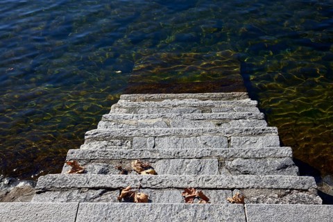 Steps into the water of Lake Maggiore on the shore in Ascona