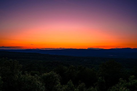 Sun sets behind the Catskills Mountains