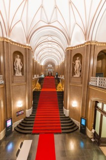 Interior of the Rotes Rathaus with red carpet and elegant staircase