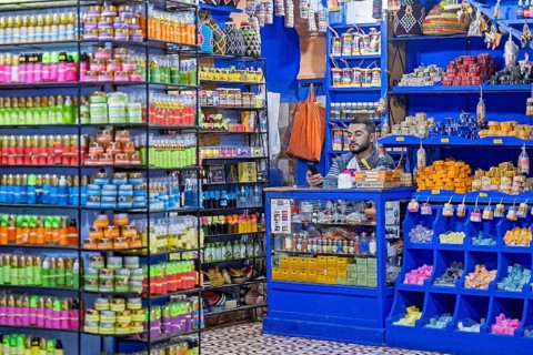 Moroccan vendor of soap in beauty shop selling cosmetics in medina