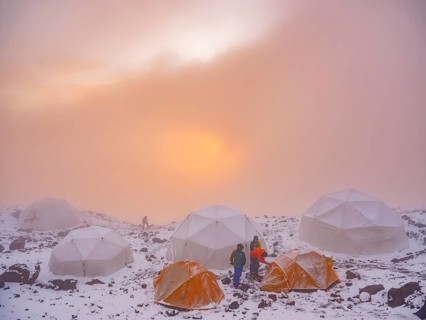 Snow-covered tents in the high camp of Chimborazo