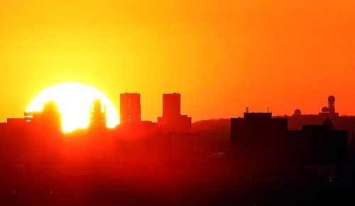 View during sunset of high-rise buildings at Potsdamer Platz and the former listening station at Teufelsberg