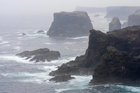 Sea stacks and cliffs in the mist at Eshaness