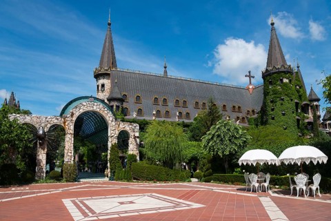 Fairytale castle with pointed towers under a sunny sky