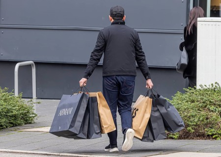 Consumer tourist lugging shopping bags
