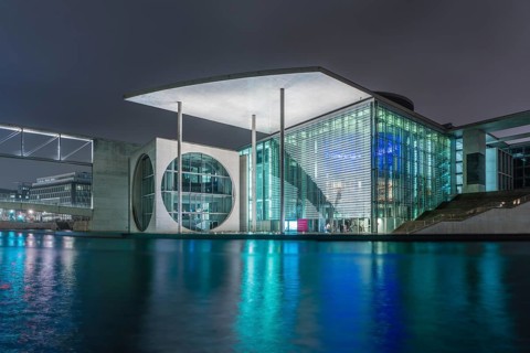 Night view of a government building with water reflection