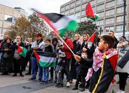 A young boy waves a Palestinian flag during the demonstration Freedom for the people of Gaza
