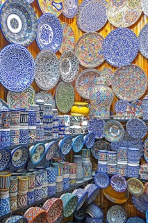 Decorative and colourful ceramics and pottery on display in souvenir shop in medina of the city Fes