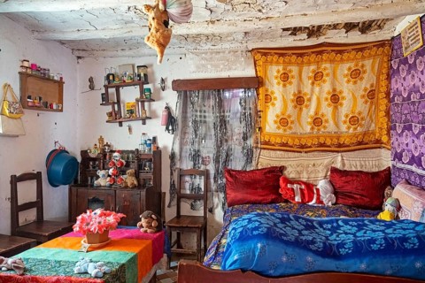 Interior of Betsileo house showing living room with bed in the Haute Matsiatra Region
